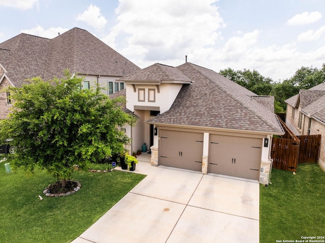 view of front of house with a front yard and a garage