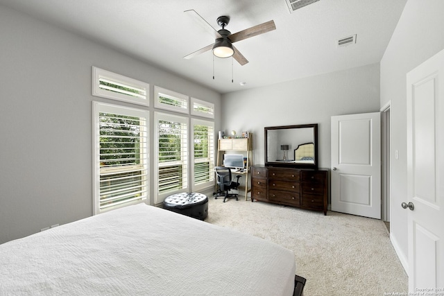 bedroom with ceiling fan and light carpet