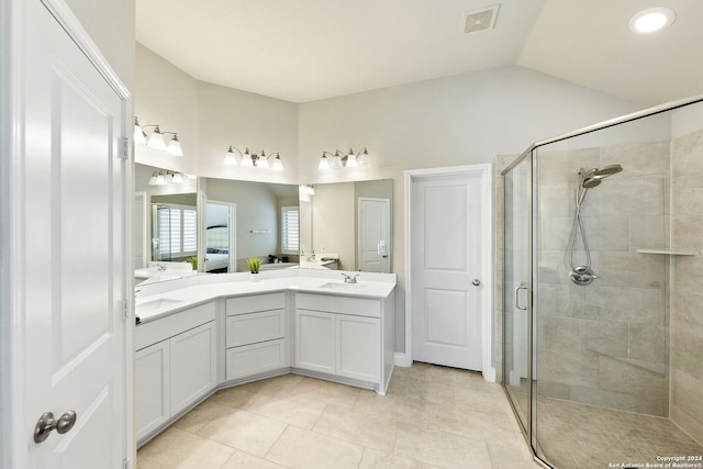 bathroom with tile patterned flooring, vanity, an enclosed shower, and vaulted ceiling