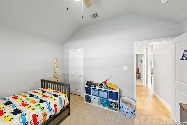 bedroom featuring ceiling fan, light colored carpet, and lofted ceiling