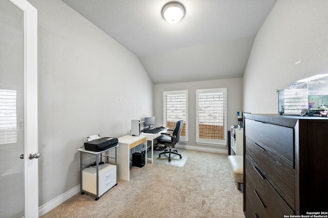 carpeted office with lofted ceiling