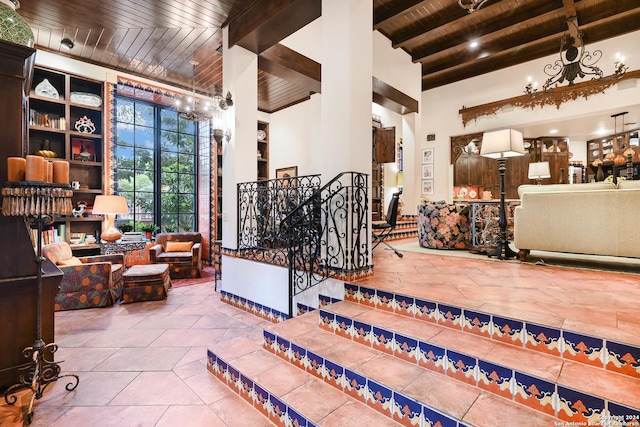 wine room featuring wood ceiling, a high ceiling, beam ceiling, and tile patterned floors