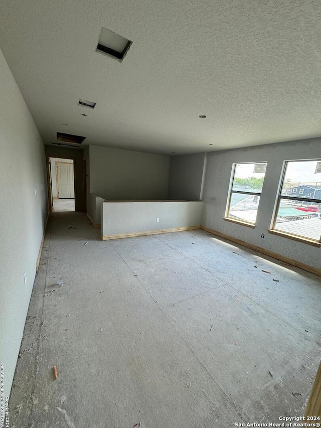 spare room with a textured ceiling