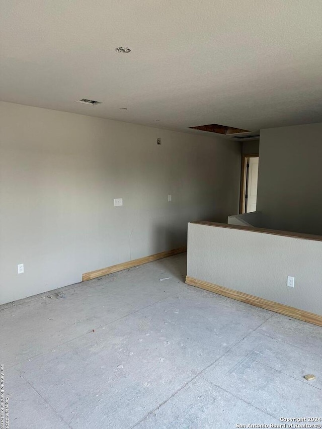 spare room with a textured ceiling