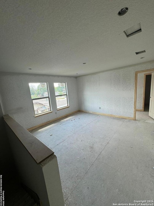 spare room with a textured ceiling