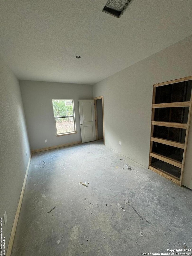 empty room featuring a textured ceiling