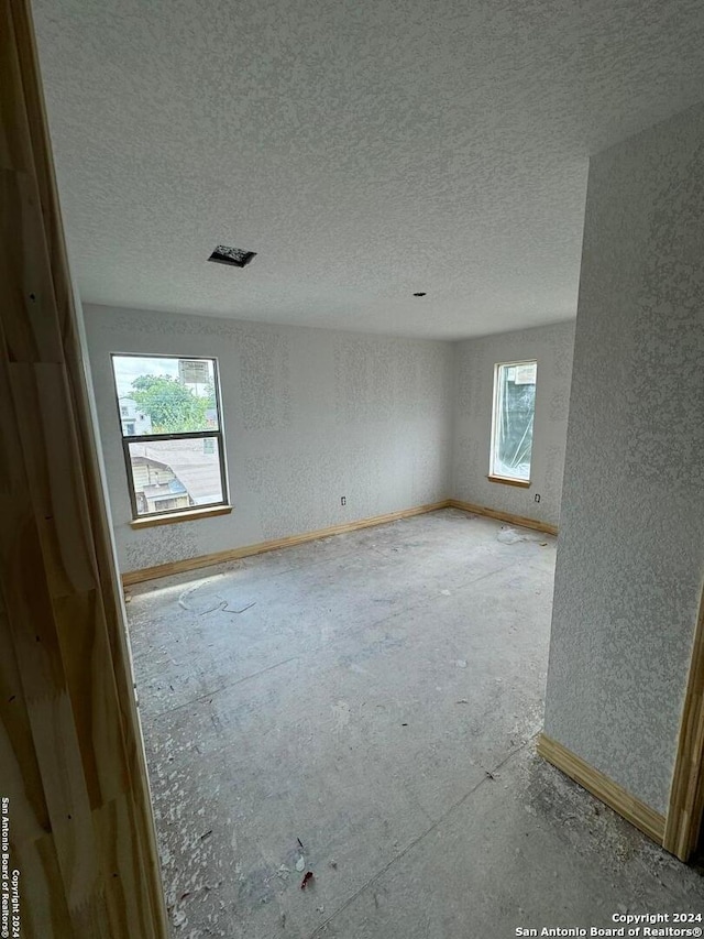 spare room featuring a textured ceiling