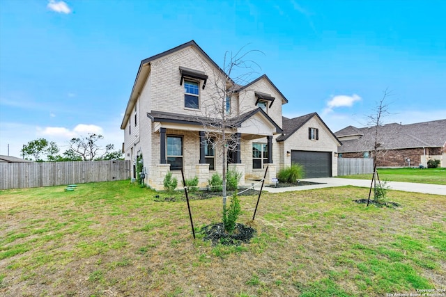 view of front of property featuring a garage and a front yard