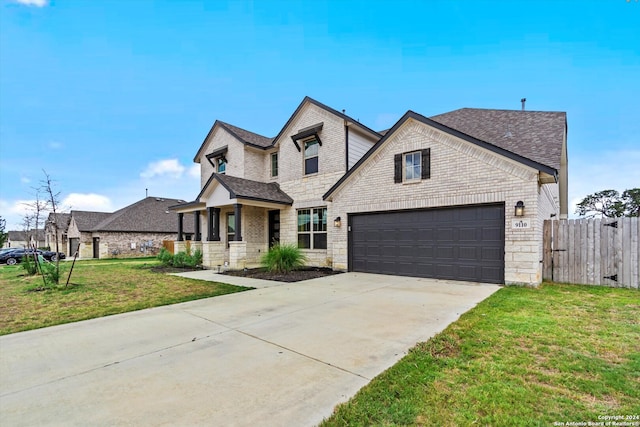 view of front of home with a front lawn and a garage