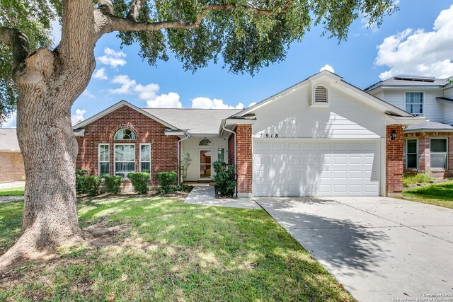 view of front of home with a garage and a front lawn