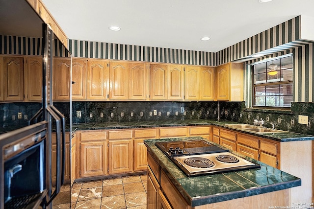 kitchen with black oven, sink, a center island, and stainless steel gas cooktop