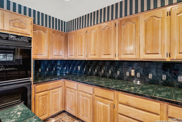 kitchen featuring decorative backsplash and double oven