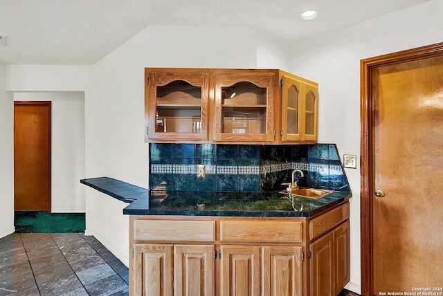 bar featuring tasteful backsplash and sink