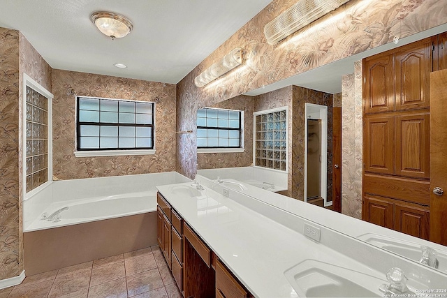 bathroom featuring tile patterned floors, a bathing tub, and vanity