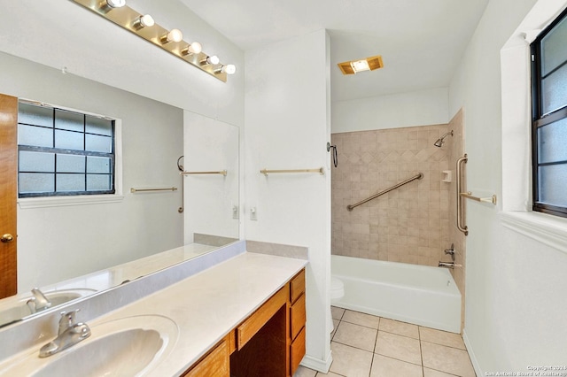 full bathroom with tile patterned flooring, vanity, toilet, and tiled shower / bath