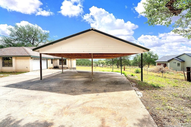 view of parking featuring a garage and a carport