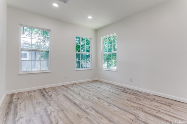 spare room featuring light hardwood / wood-style flooring