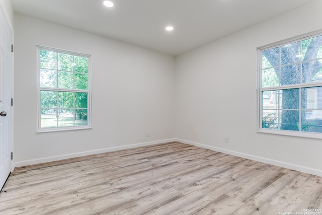 unfurnished room with light wood-type flooring