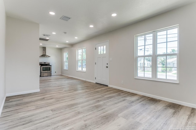 unfurnished living room with light hardwood / wood-style flooring