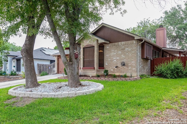 ranch-style home with a garage and a front yard