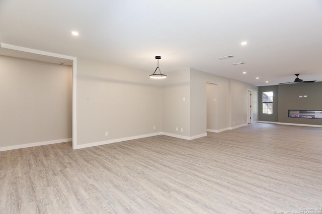 empty room featuring ceiling fan and light hardwood / wood-style flooring