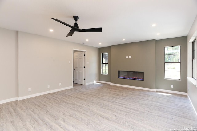 unfurnished living room featuring light hardwood / wood-style floors and ceiling fan