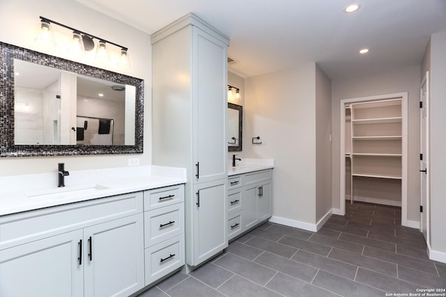 bathroom featuring built in shelves, vanity, tile patterned floors, and walk in shower