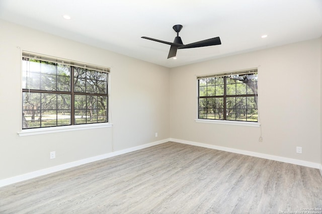 empty room with light wood-type flooring and ceiling fan