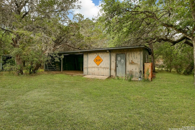 view of outbuilding with a lawn