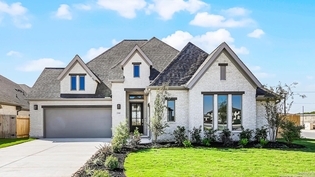 view of front of home featuring a garage and a front lawn