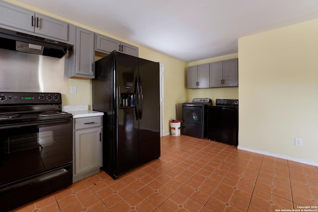 kitchen featuring black appliances, gray cabinetry, independent washer and dryer, and light tile patterned floors