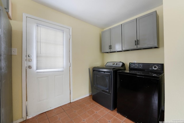 washroom with cabinets, light tile patterned flooring, and washing machine and dryer