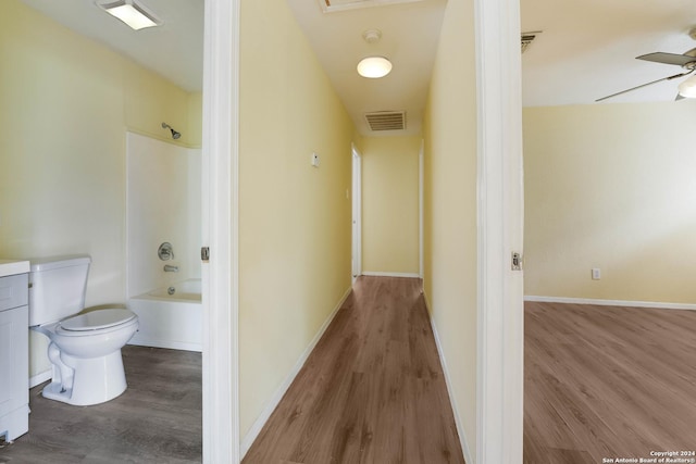 hallway with hardwood / wood-style flooring