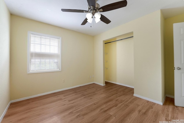 unfurnished bedroom with a closet, light hardwood / wood-style flooring, and ceiling fan