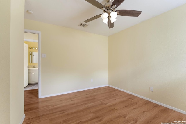 empty room with ceiling fan and hardwood / wood-style floors