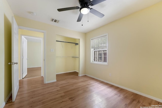 unfurnished bedroom with hardwood / wood-style floors, ceiling fan, and a closet