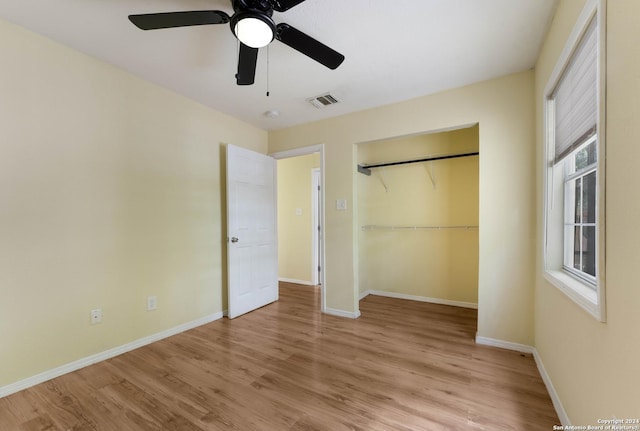 unfurnished bedroom featuring ceiling fan, light wood-type flooring, and a closet