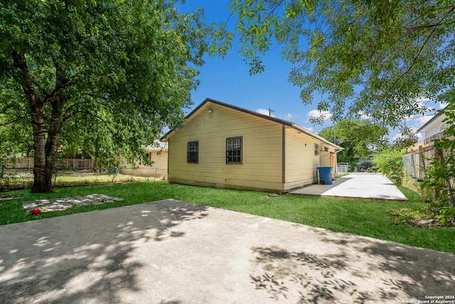 rear view of property featuring a patio area and a yard