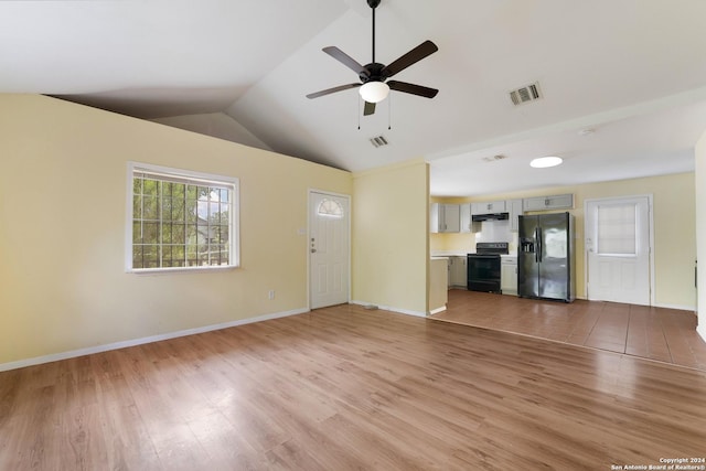 unfurnished living room with ceiling fan, lofted ceiling, and light hardwood / wood-style flooring