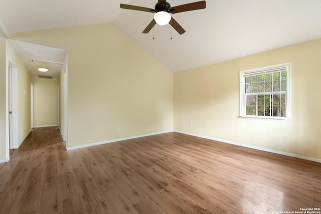 spare room featuring ceiling fan, hardwood / wood-style floors, and vaulted ceiling