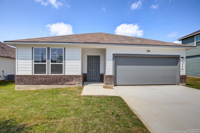 ranch-style home with cooling unit, a garage, and a front yard