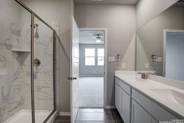 bathroom with vanity, tile patterned floors, ceiling fan, and a shower with shower door