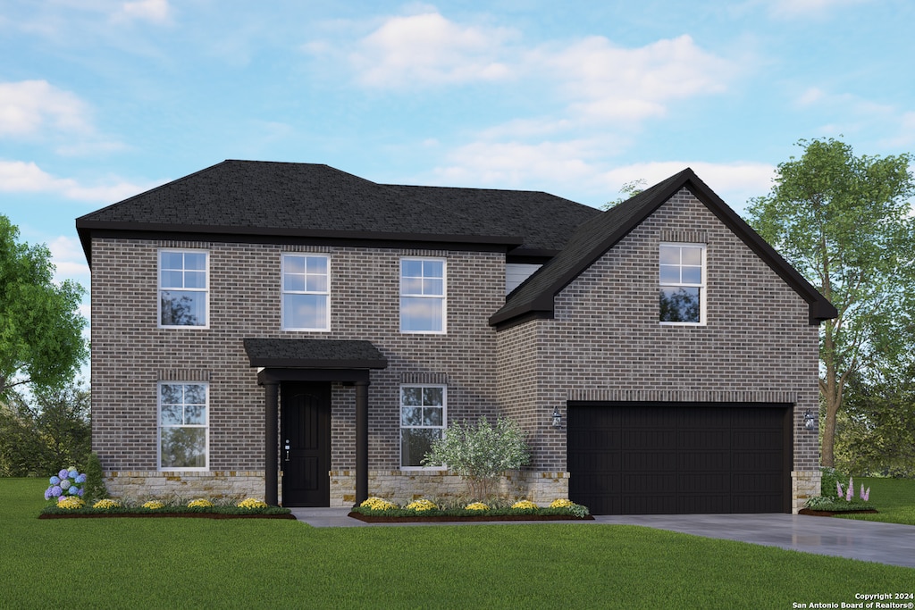 view of front of home featuring a front yard and a garage