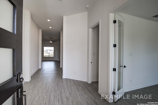 hall with hardwood / wood-style flooring