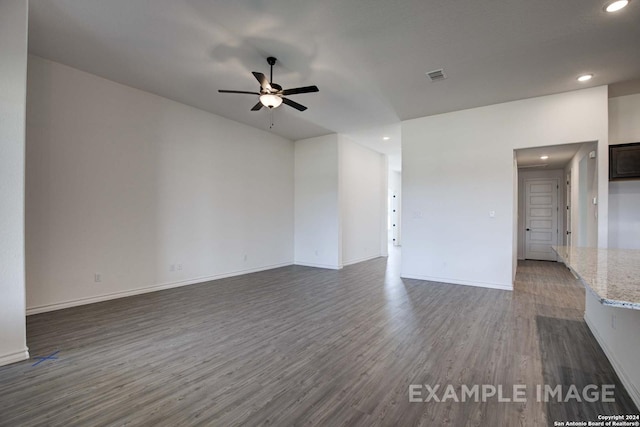 unfurnished living room featuring ceiling fan and dark hardwood / wood-style flooring