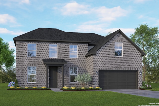 view of front of property featuring a front yard and a garage