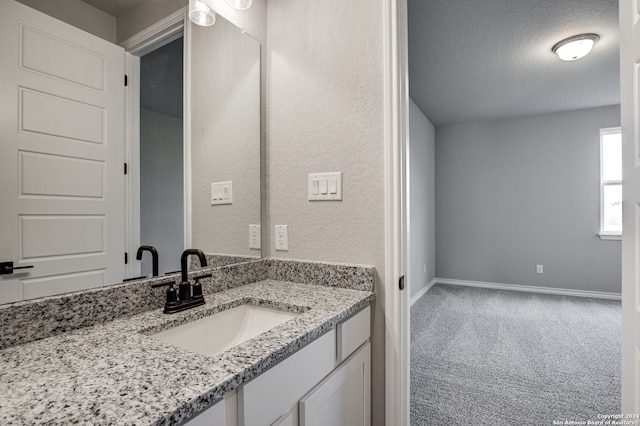 bathroom with vanity and a textured ceiling