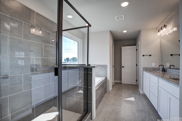 bathroom featuring vanity, tile patterned floors, and shower with separate bathtub