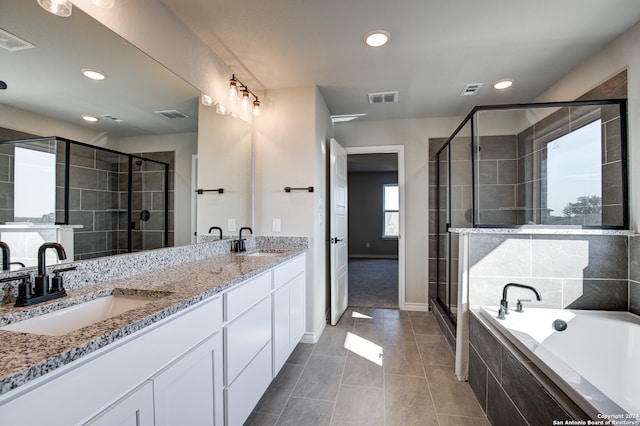 bathroom with vanity, independent shower and bath, and tile patterned flooring