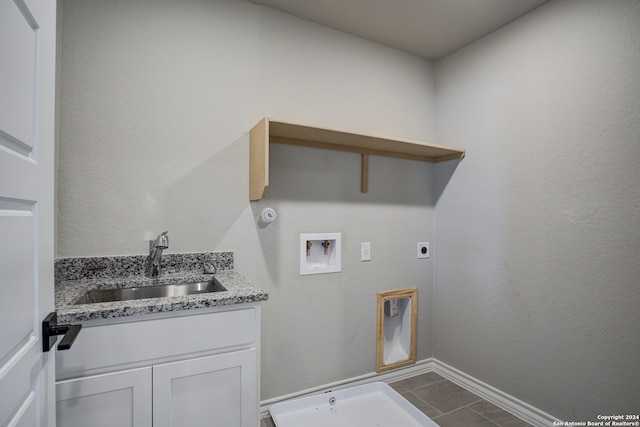 clothes washing area with gas dryer hookup, hookup for a washing machine, hookup for an electric dryer, sink, and tile patterned flooring